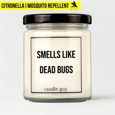 Citronella candle with the quote “Smells Like Dead Bugs” in a white jar with black lid – studio shot