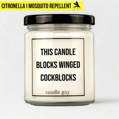 Citronella candle with the quote “This candle blocks winged cockblocks” in a white jar with black lid – studio shot