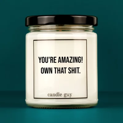 Discover our bestselling quote candle: "You're Amazing! Own That Shit." – handcrafted with love and 100% soy wax. A true original by candle guy.